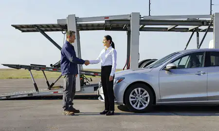 Vehicle owner beside their delivered car in Jackson, Michigan, United States