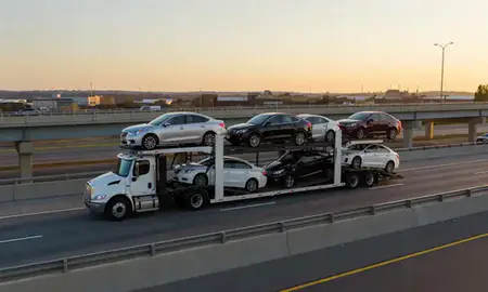Car transporter with the Kalamazoo, Michigan, United States skyline behind it