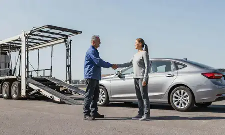 Vehicle owner beside their delivered car in Lansing, Michigan, United States