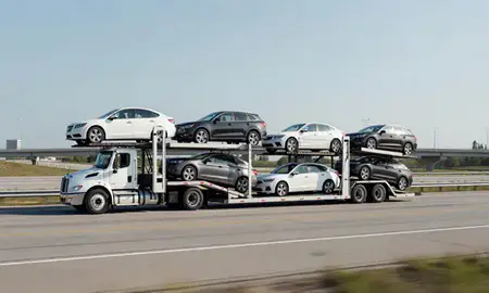 Multi-level car carrier on the highway to Novi, Michigan, United States