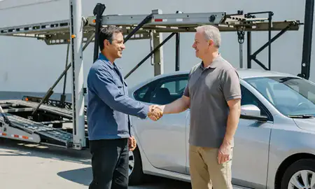 Vehicle owner beside their delivered car in Sterling Heights, Michigan, United States