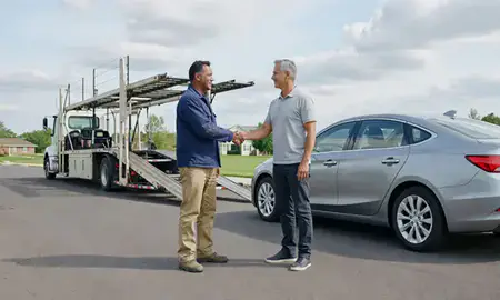 Vehicle owner beside their delivered car in Troy, Michigan, United States