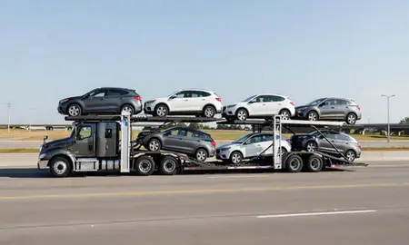 Multi-level car carrier on the highway to Warren, Michigan, United States