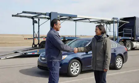 Vehicle owner beside their delivered car in Minnesota, United States