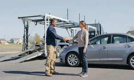 Vehicle owner beside their delivered car in Apple Valley, Minnesota, United States