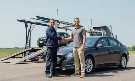 Vehicle owner beside their delivered car in Plymouth, Minnesota, United States