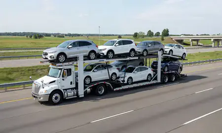 Multi-level car carrier on the highway to Roseville, Minnesota, United States