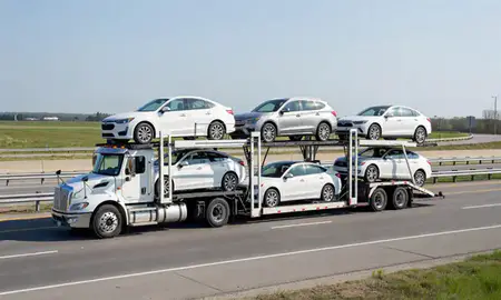 Multi-level car carrier on the highway to St. Paul, Minnesota, United States