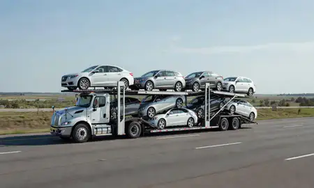Multi-level car carrier on the highway to Mississippi, United States