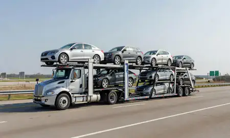 Multi-level car carrier on the highway to Clinton, Mississippi, United States