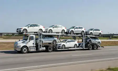 Multi-level car carrier on the highway to Columbus, Mississippi, United States