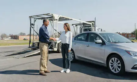 Vehicle owner beside their delivered car in Jackson, Mississippi, United States