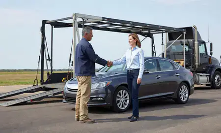 Vehicle owner beside their delivered car in Meridian, Mississippi, United States