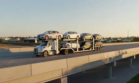 Car transporter with the Olive Branch, Mississippi, United States skyline behind it