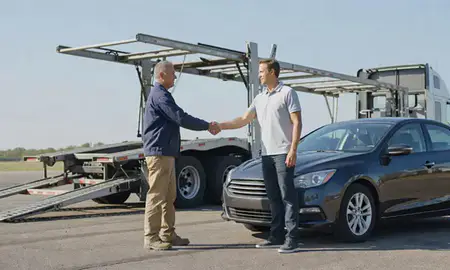 Vehicle owner beside their delivered car in Missouri, United States