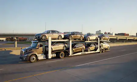 Car transporter with the Columbia, Missouri, United States skyline behind it