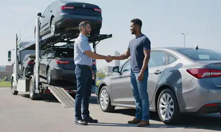 Vehicle owner beside their delivered car in Kansas City, Missouri, United States