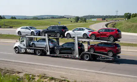 Multi-level car carrier on the highway to Liberty, Missouri, United States
