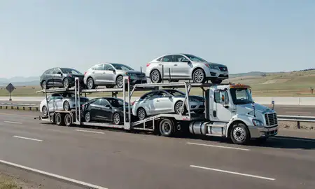 Multi-level car carrier on the highway to Anaconda, Montana, United States