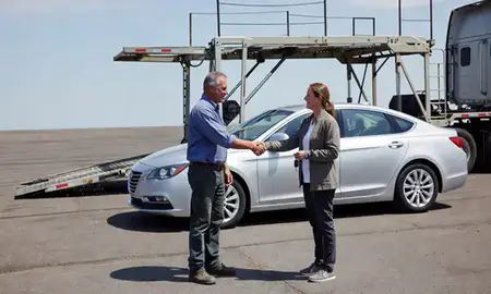 Vehicle owner beside their delivered car in Anaconda, Montana, United States