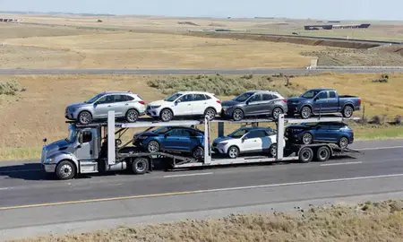 Multi-level car carrier on the highway to Belgrade, Montana, United States