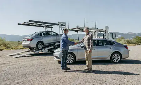Vehicle owner beside their delivered car in Bigfork, Montana, United States