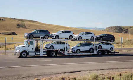 Multi-level car carrier on the highway to Bozeman, Montana, United States