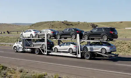 Multi-level car carrier on the highway to Butte, Montana, United States