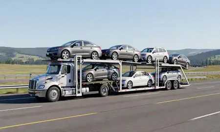 Multi-level car carrier on the highway to Columbia Falls, Montana, United States
