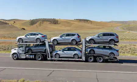Multi-level car carrier on the highway to Four Corners, Montana, United States