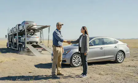 Vehicle owner beside their delivered car in Four Corners, Montana, United States