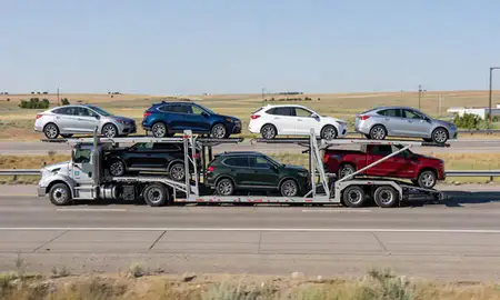 Multi-level car carrier on the highway to Great Falls, Montana, United States