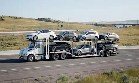 Multi-level car carrier on the highway to Hamilton, Montana, United States