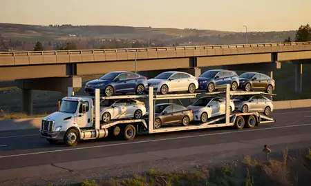 Car transporter with the Helena Valley Northwest, Montana, United States skyline behind it