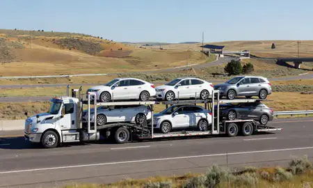 Multi-level car carrier on the highway to Helena Valley Southeast, Montana, United States