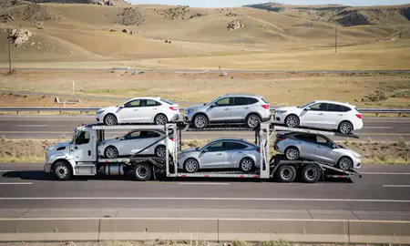 Multi-level car carrier on the highway to Helena Valley West Central, Montana, United States