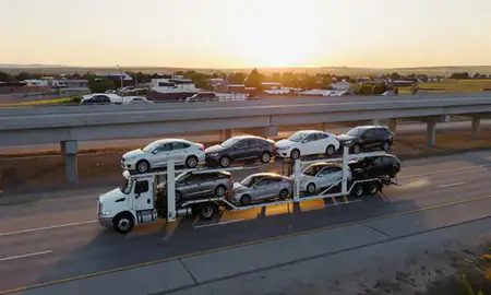 Car transporter with the Lewistown, Montana, United States skyline behind it