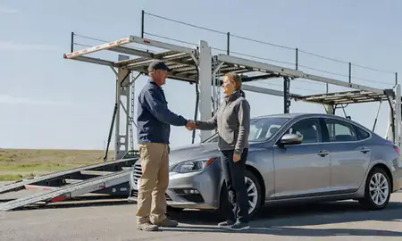 Vehicle owner beside their delivered car in Lolo, Montana, United States