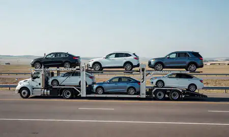Multi-level car carrier on the highway to Malmstrom AFB, Montana, United States