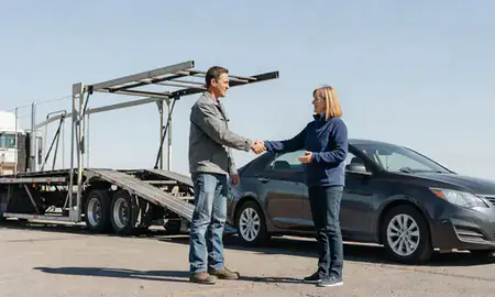 Vehicle owner beside their delivered car in Miles City, Montana, United States