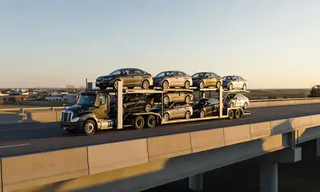 Car transporter with the Miles City, Montana, United States skyline behind it