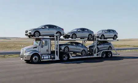 Multi-level car carrier on the highway to Orchard Homes, Montana, United States