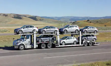 Multi-level car carrier on the highway to Polson, Montana, United States