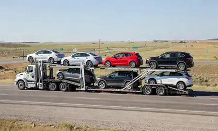Multi-level car carrier on the highway to Sidney, Montana, United States
