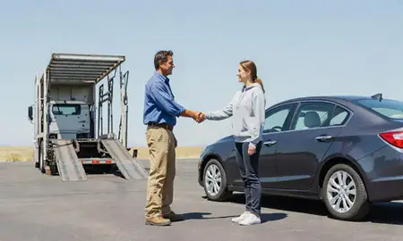 Vehicle owner beside their delivered car in Sidney, Montana, United States