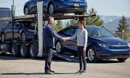 Vehicle owner beside their delivered car in Whitefish, Montana, United States