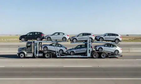 Multi-level car carrier on the highway to Columbus, Nebraska, United States