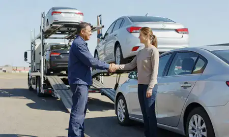 Vehicle owner beside their delivered car in Fremont, Nebraska, United States