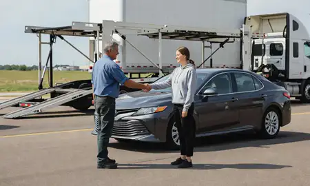 Vehicle owner beside their delivered car in La Vista, Nebraska, United States
