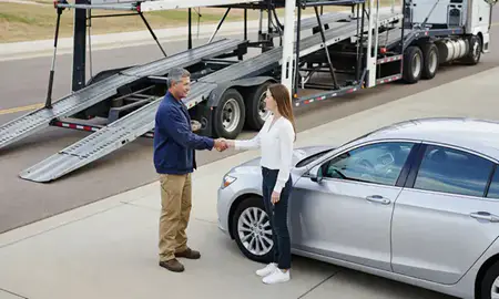 Vehicle owner beside their delivered car in Papillion, Nebraska, United States